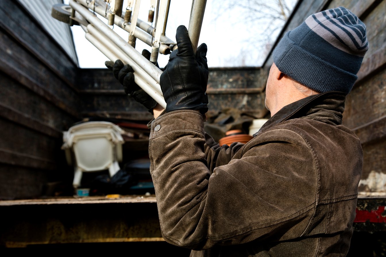 Workman tossing junk in back of truck